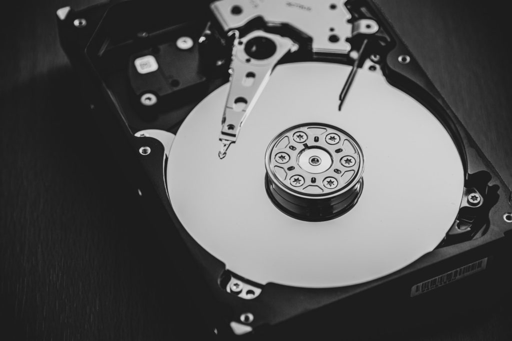 Open hard disk drive showing platters and actuator arm