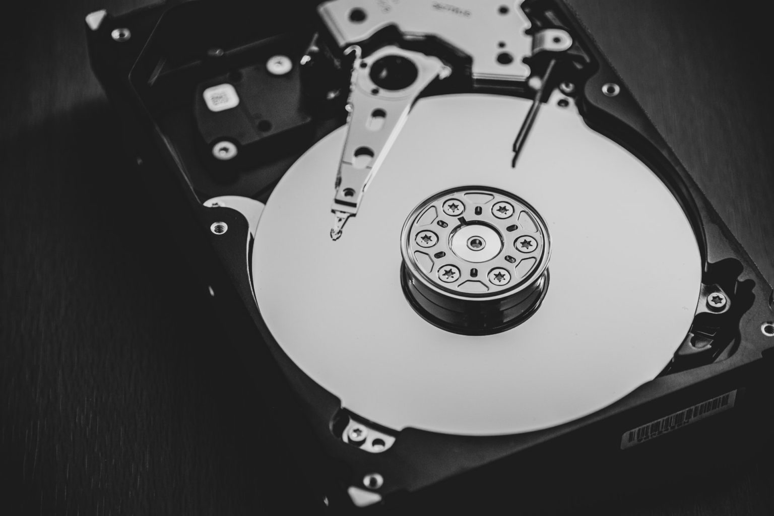 Open hard disk drive showing platters and actuator arm